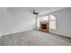 Bright living room features a stone fireplace, modern fan, and new light gray flooring at 8789 Villa Alex Ave, Las Vegas, NV 89147