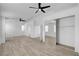 Open main bedroom with hardwood floors, ceiling fan, and a mirrored closet, complemented by natural light and closet space at 8789 Villa Alex Ave, Las Vegas, NV 89147