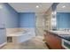 Bathroom featuring a soaking tub, glass-enclosed shower, and modern vanity at 900 Las Vegas Blvd # 1209, Las Vegas, NV 89101