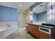 Bathroom featuring a soaking tub, glass-enclosed shower, and modern vanity at 900 Las Vegas Blvd # 1209, Las Vegas, NV 89101