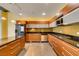 Well-lit kitchen featuring stainless steel appliances, wooden cabinets, and mosaic tile backsplash at 900 Las Vegas Blvd # 1209, Las Vegas, NV 89101
