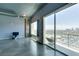 Living room featuring polished concrete floors, expansive windows, a balcony, and scenic city views at 900 Las Vegas Blvd # 1209, Las Vegas, NV 89101