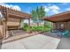 Spacious backyard with a covered patio, a pergola, and a well-manicured lawn, ideal for outdoor gatherings at 903 Billings St, Henderson, NV 89002