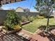 Well-manicured backyard featuring vibrant flower beds, green lawn, and mature landscaping at 903 Billings St, Henderson, NV 89002