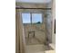 Updated bath with custom tile, shower head, and built-in niche with window at 903 Billings St, Henderson, NV 89002