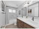 Elegant bathroom with dual sinks, marble tile shower, and modern fixtures for a luxurious and functional space at 903 Billings St, Henderson, NV 89002
