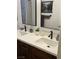 Bathroom featuring dual sinks, quartz countertops, and stylish hardware, blending functionality with modern design at 903 Billings St, Henderson, NV 89002