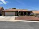 Charming single-story home with a well-maintained front yard and a two-car garage at 903 Billings St, Henderson, NV 89002