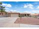 Charming single-story home featuring a tile roof, desert landscaping, and a two-car garage at 903 Billings St, Henderson, NV 89002