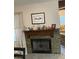 Stone fireplace with wooden mantle, decorative accents, and adjacent view to the open living space at 903 Billings St, Henderson, NV 89002