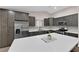 Open kitchen featuring a large center island with stainless steel appliances and tiled backsplash at 903 Billings St, Henderson, NV 89002