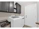 Convenient laundry room with front-load washer and dryer, ample storage cabinets, and easy access to the exterior at 903 Billings St, Henderson, NV 89002