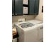 Well-equipped laundry room featuring front load washer and dryer with built-in cabinets and storage space at 903 Billings St, Henderson, NV 89002