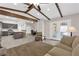 Open-concept living area with kitchen, dining, and living spaces plus beams and access to the patio at 903 Billings St, Henderson, NV 89002