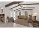 Relaxing living room with wood beam ceiling, fireplace, and french doors to the exterior at 903 Billings St, Henderson, NV 89002