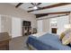 Bright main bedroom featuring exposed beams, ensuite bath with barn door, and neutral color palette at 903 Billings St, Henderson, NV 89002