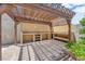 Outdoor kitchen and barbecue area with built-in storage, counter space, and shaded pergola at 903 Billings St, Henderson, NV 89002