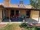 Inviting covered patio featuring comfortable seating, stylish rug, and serene backyard views at 903 Billings St, Henderson, NV 89002