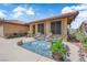 Charming outdoor patio with seating, mature landscaping, and inviting curb appeal at 903 Billings St, Henderson, NV 89002