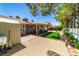 A backyard view with artificial grass, a patio, and trees at 906 Sitting Bull Dr, Henderson, NV 89014