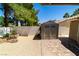 Fully fenced backyard featuring a storage shed, gravel, and brick paver patio area at 906 Sitting Bull Dr, Henderson, NV 89014