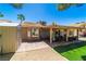 Large backyard featuring a patio, storage shed, covered seating area, and artificial grass at 906 Sitting Bull Dr, Henderson, NV 89014