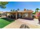 A backyard with a covered patio, artificial grass, and desert landscaping at 906 Sitting Bull Dr, Henderson, NV 89014