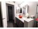 A modern bathroom with an orange sink bowl, gray cabinets, and white walls at 906 Sitting Bull Dr, Henderson, NV 89014