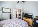 Cozy bedroom featuring patterned bedding, a ceiling fan, and a doorway leading to another room at 906 Sitting Bull Dr, Henderson, NV 89014