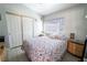 Bedroom with light walls, patterned bedspread, and natural light from the window, creating a cozy space at 906 Sitting Bull Dr, Henderson, NV 89014