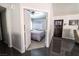 View from doorway of bedroom with patterned bedding and open door to entrance foyer with dark door at 906 Sitting Bull Dr, Henderson, NV 89014