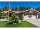Charming single-story home with well-manicured lawn and mature landscaping with desert accents at 906 Sitting Bull Dr, Henderson, NV 89014