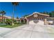 Well-maintained home featuring a two-car garage, desert landscaping, and a classic tile roof in a sunny setting at 906 Sitting Bull Dr, Henderson, NV 89014