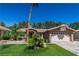 Lovely home with a tile roof, two-car garage, and easy-care front yard featuring artificial grass and desert landscaping at 906 Sitting Bull Dr, Henderson, NV 89014