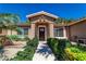 Inviting front entrance with lush landscaping and decorative stonework leading to a traditional front door at 906 Sitting Bull Dr, Henderson, NV 89014