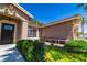 Charming desert-style home featuring manicured landscaping, mature trees, and a decorative stone bench at 906 Sitting Bull Dr, Henderson, NV 89014