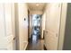 Hallway view leading to dining area and bathroom featuring dark ceramic floors and neutral paint at 906 Sitting Bull Dr, Henderson, NV 89014