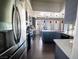 Modern kitchen features stainless steel appliances, dark cabinetry, and wood-look tile flooring at 906 Sitting Bull Dr, Henderson, NV 89014