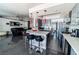 Open-concept kitchen with an island, red pendant lights, and seating overlooking the living area at 906 Sitting Bull Dr, Henderson, NV 89014
