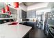 Bright kitchen featuring gray cabinetry, stainless steel appliances, quartz countertops, and red pendant lights at 906 Sitting Bull Dr, Henderson, NV 89014