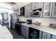 Kitchen featuring gray cabinetry, stainless appliances, wine fridge, coffee station, and quartz countertops at 906 Sitting Bull Dr, Henderson, NV 89014