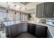 Well-lit kitchen with an island, modern appliances, and sleek gray cabinets at 906 Sitting Bull Dr, Henderson, NV 89014