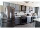 Well-equipped kitchen with stainless steel appliances, gray cabinets, and ample counter space at 906 Sitting Bull Dr, Henderson, NV 89014