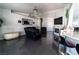 Cozy living room with gray wood floors, fireplace, and comfortable seating, adjacent to kitchen at 906 Sitting Bull Dr, Henderson, NV 89014