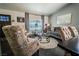 Cozy living room featuring comfortable seating, a large window, and stylish decor at 906 Sitting Bull Dr, Henderson, NV 89014