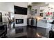 Bright living room with fireplace, TV, art, and view into kitchen/dining area at 906 Sitting Bull Dr, Henderson, NV 89014