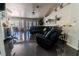 Comfortable living room with black leather sectional, leading to a dining area and kitchen at 906 Sitting Bull Dr, Henderson, NV 89014