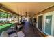 A covered patio with ample seating, ceiling fans, and a view of the landscaped backyard at 906 Sitting Bull Dr, Henderson, NV 89014