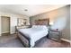 A bedroom features a comfortable bed with a decorative headboard, and mirrored accents at 908 N 24Th St, Las Vegas, NV 89101