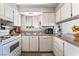 This kitchen features white cabinets, granite countertops, and modern appliances at 908 N 24Th St, Las Vegas, NV 89101